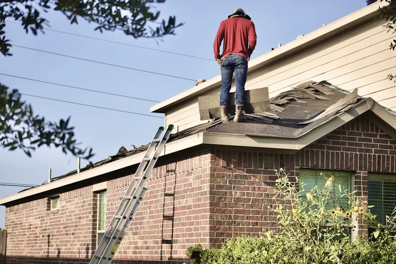 Professional roofer working on a residential roof in Moberly